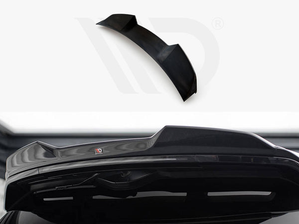 A black car spoiler, designed for aerodynamics, is positioned against a white background with branding visible. Its sleek design complements the rear of a vehicle, enhancing performance aesthetics.