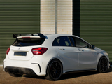 A white Mercedes A45 AMG car is parked outside, featuring a rear spoiler and dual exhausts. It's situated against a background of green horizontal metal shutters.