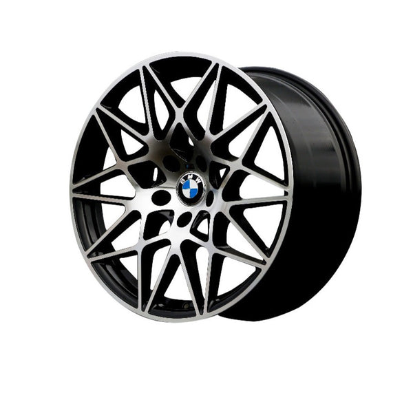 A sleek, intricate multi-spoke BMW car wheel with a central blue and white logo is displayed against a plain white background, emphasizing its geometric design and smooth finish.