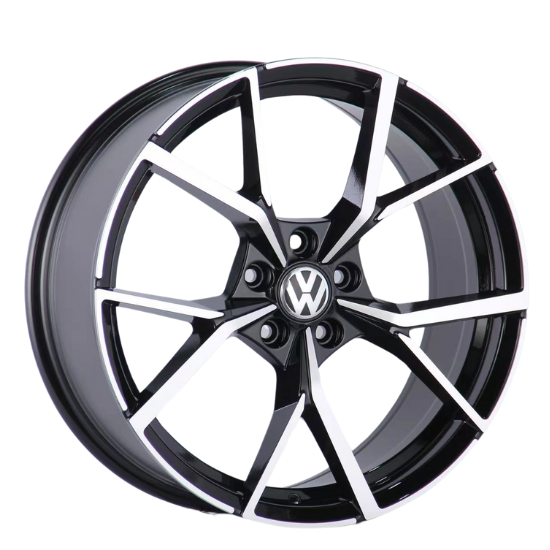 A black and silver alloy wheel with the Volkswagen logo at the center. The wheel's angular spoke design appears sleek and modern, set against a plain white background.