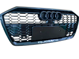 A black car grille displays three circular emblems at the top and “quattro” text at the bottom, featuring a honeycomb pattern.