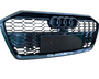 A black car grille displays three circular emblems at the top and “quattro” text at the bottom, featuring a honeycomb pattern.