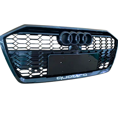 A black car grille displays three circular emblems at the top and “quattro” text at the bottom, featuring a honeycomb pattern.
