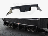 A car rear diffuser with aerodynamic fins is positioned above. Below, it's installed on a vehicle's rear bumper, featuring four exhaust pipes. The vehicle rests on a checkered floor.