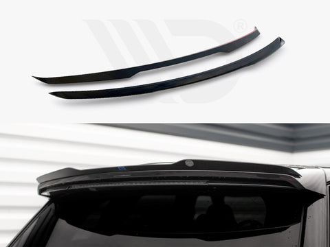 Two black spoilers are displayed; one is installed above a car's rear window in a garage-like setting with white walls.