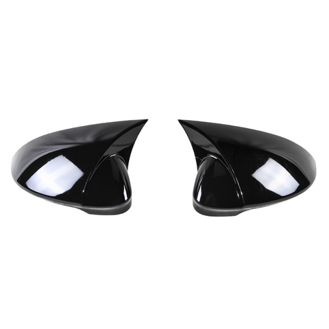 Two black, glossy side mirrors with aerodynamic design sit facing each other against a plain white background, reflecting light and showing smooth surface contours.