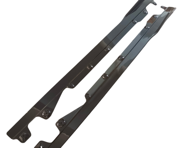 Two long, metallic bars with multiple bolt holes, oriented diagonally. The bars have a reflective surface and are set against a plain, white background.