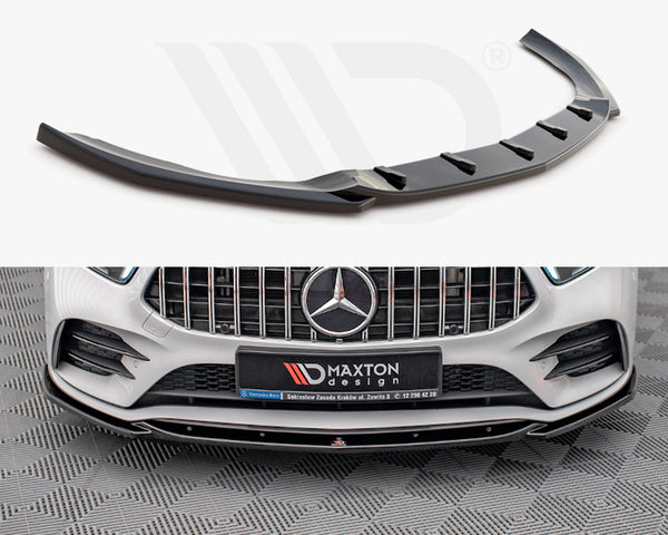 A black car front splitter is displayed; it enhances the aerodynamics of a white Mercedes-Benz with a prominent grille. A sign reads “Maxton design” on the bumper.