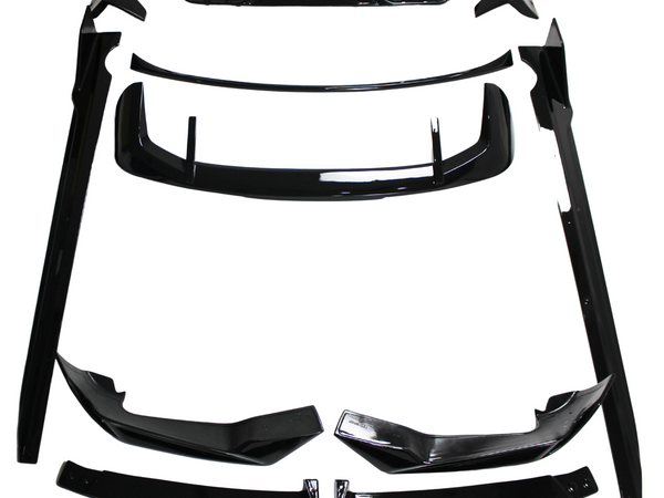 Black car body kit components, including spoilers and side skirts, are arranged on a white background. The parts are neatly organized, showcasing their glossy finish and aerodynamic design.