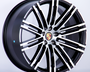 A black and silver alloy wheel with a multi-spoke design featuring the Porsche logo at the center, displayed against a plain white background.