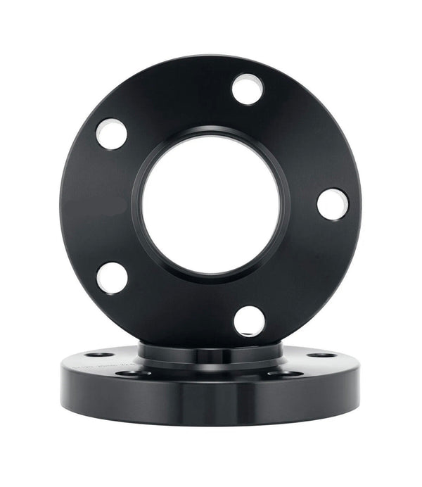 A black metal flange with multiple holes is stacked on another similar flange against a plain white background, suggesting industrial or mechanical use.