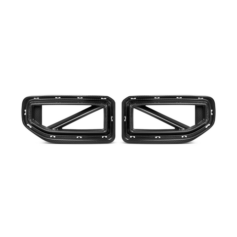 Two carbon fiber car exhaust trim pieces, designed with rectangular frames and diagonal supports, are positioned side by side against a plain white background.