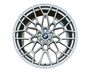 A silver alloy wheel with intricate spoke design, featuring a central blue and white logo, set against a plain white background.
