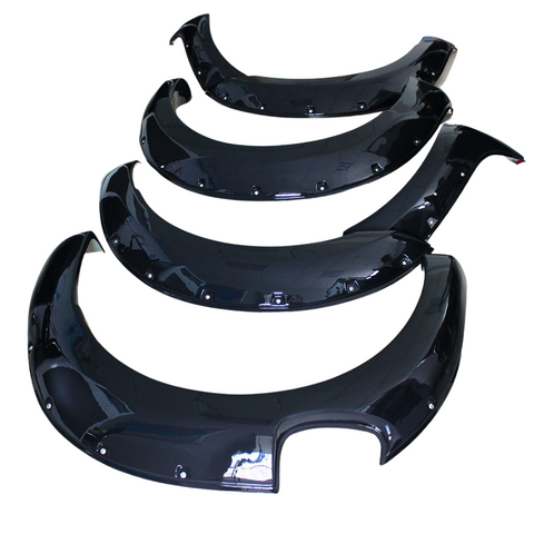 Four glossy black fender flares, arranged in descending size order, are placed against a plain white background, displaying their smooth curved design and attached mounting holes.