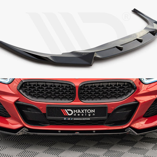 A black car front splitter, designed to enhance aerodynamics, is displayed above a red car's front bumper featuring a matching splitter. The license plate reads "MAXTON DESIGN."