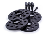 Four black wheel spacers with multiple holes labeled 