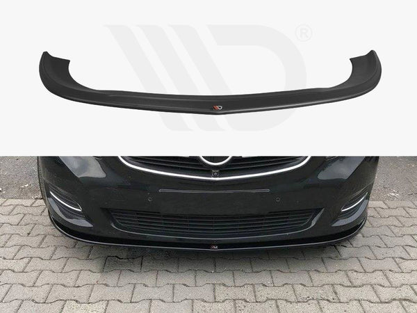 A black car front lip spoiler is shown both separately and installed on a dark-colored car, enhancing its aerodynamics. The car is parked on a stone-paved area.