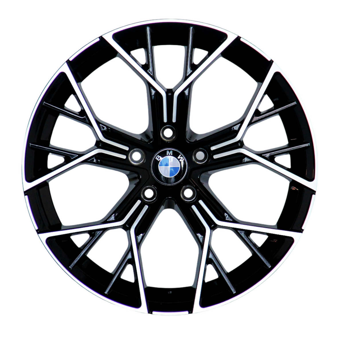 A black alloy wheel with intricate silver spokes and a central BMW logo, resting against a white background.