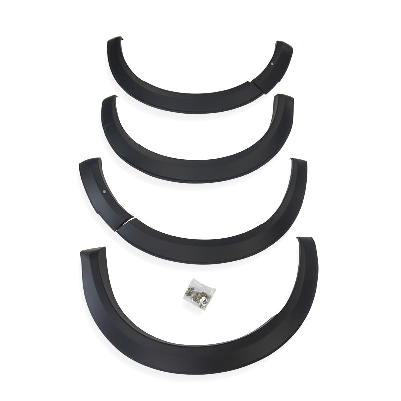Four black plastic fender flares arranged vertically, each slightly curved, with a small bag of screws below, placed against a plain white background.