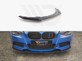 A black car front splitter is shown separately above and affixed to a blue car’s front bumper. The car is pictured on concrete. Text: 