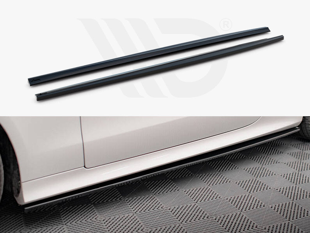 Black side skirts rest above an image of a white car's side panel. The car is parked on a patterned surface, showcasing the accessory's application.