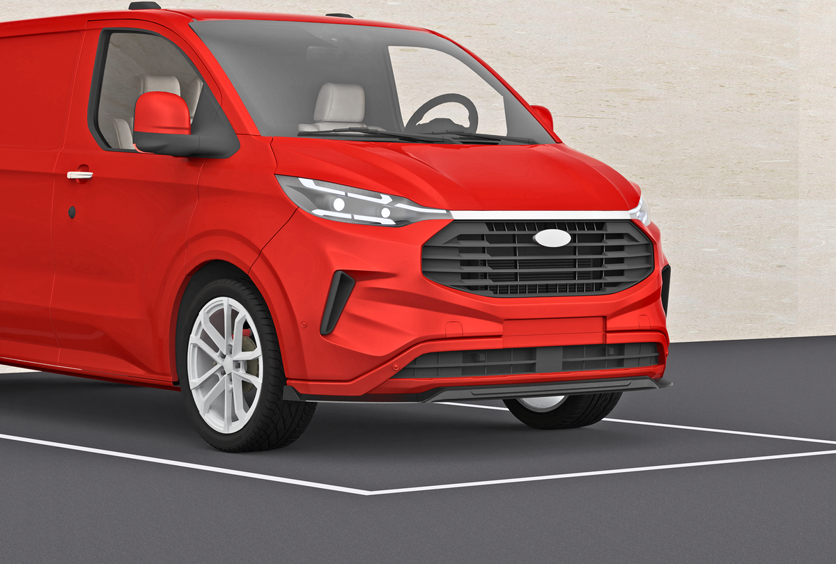 A red van parked within a designated space on a gray asphalt surface with a beige wall in the background, showcasing its front and side profile.