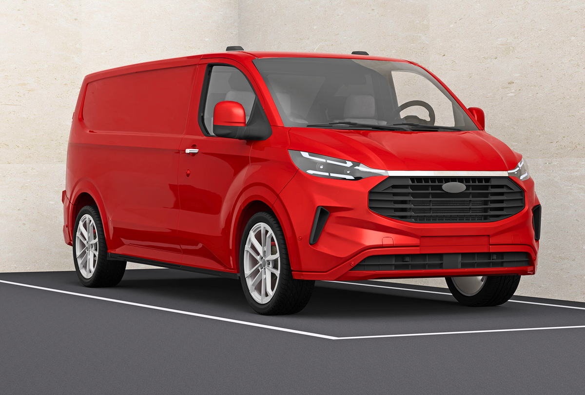 A red cargo van is parked in an indoor setting, featuring modern headlights and a prominent front grille. The light-colored walls provide a neutral backdrop.