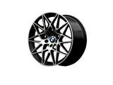 A black alloy wheel with intricate interwoven spokes, featuring a central BMW logo, displayed on a plain white background.