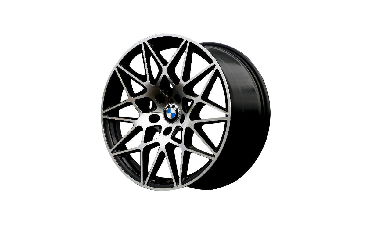 A black alloy wheel with intricate interwoven spokes, featuring a central BMW logo, displayed on a plain white background.