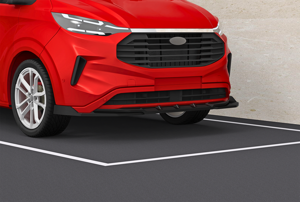 A red car's front is parked in a designated parking space, against a light beige wall. The car features a modern design with a prominent grille and sleek headlights.