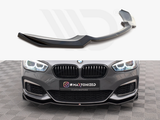 A black front spoiler sits on a white background. Below, a grey BMW with bright headlights displays the spoiler attached. Text on license plate: 