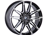 A car wheel with a sleek, black and silver alloy rim features a multi-spoke design. The BMW logo is in the center, adding a distinct brand identity.
