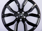 A shiny black alloy wheel features prominent spokes and a 