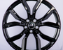 A shiny black alloy wheel features prominent spokes and a "Range Rover" logo at its center, set against a plain white background.