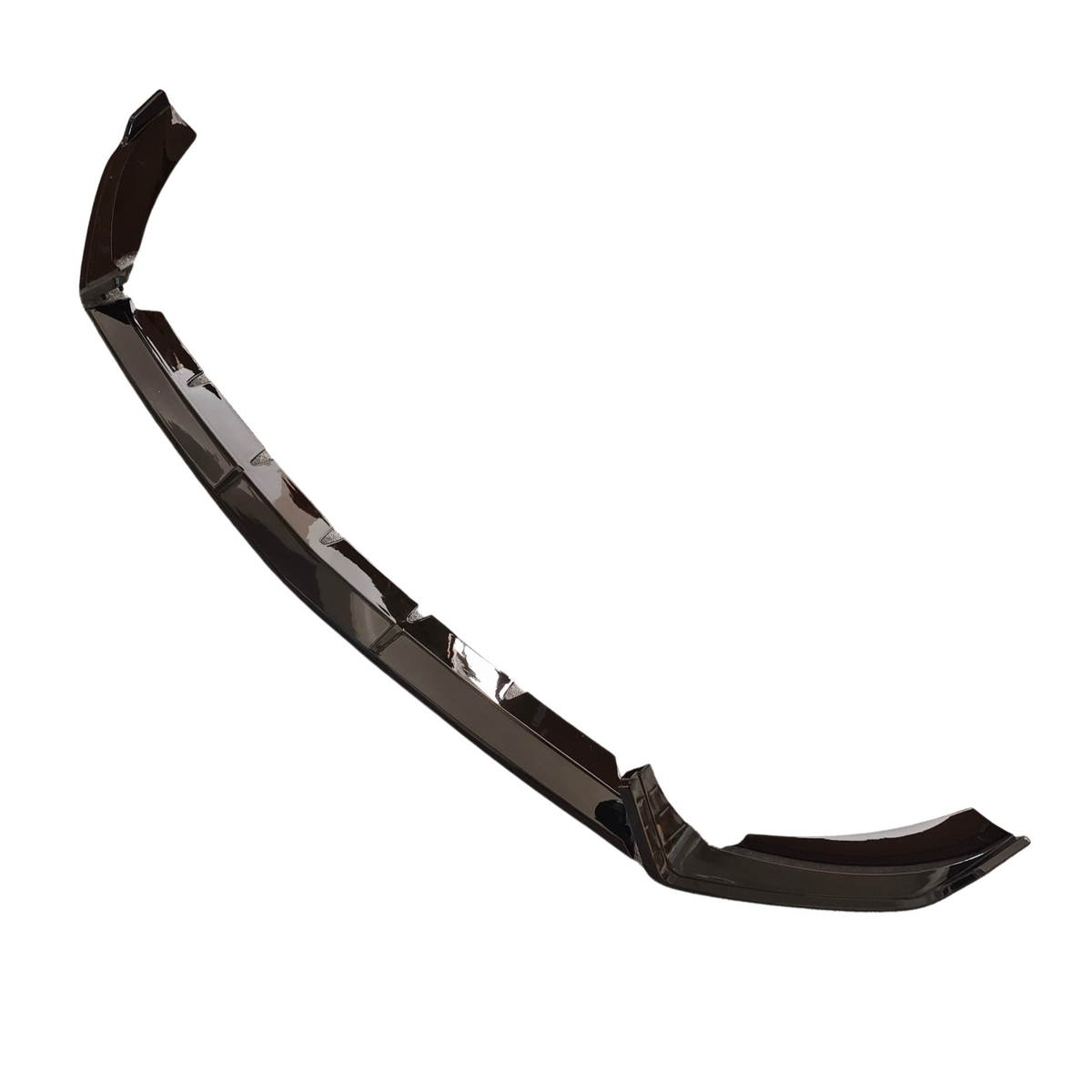 Curved plastic car part sits against a plain white background, featuring angular segments and smooth, glossy black surface.