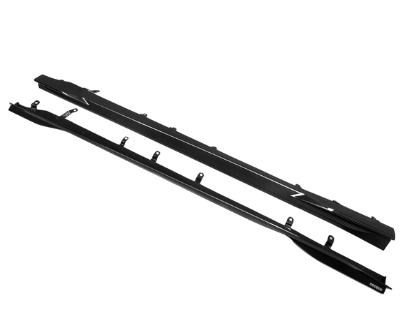 Two black side skirts with mounting brackets placed against a plain white background, each featuring a carbon fiber texture and the text "Z" and "SARD700."