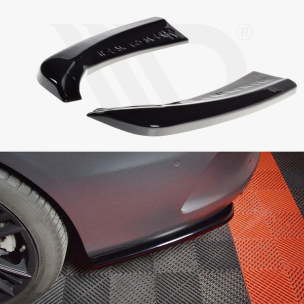Black car splitters are displayed separately on a white background and installed on a vehicle's rear bumper. The vehicle is on a red and black checkered floor.