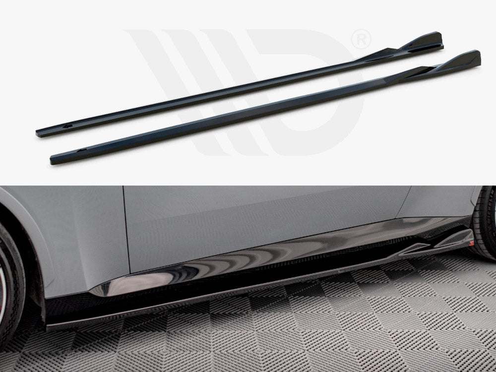 Two black side skirts, shown separately and installed on a car with a gray body, resting on a checkered floor. The skirts enhance the car's aerodynamic appearance.