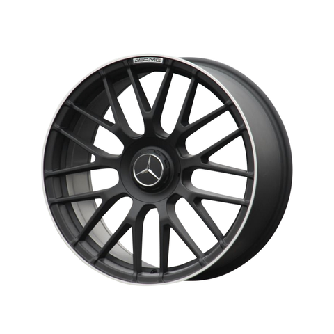 A black, multi-spoke car wheel rim features a Mercedes logo at its center, with "AMG" inscribed along the rim. It is displayed on a plain white background.