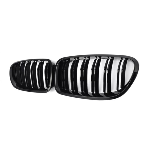 A pair of black car grilles with vertical slats, positioned side by side, set against a plain white background.
