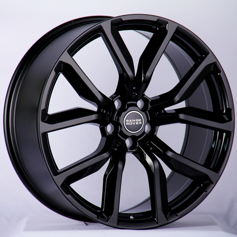 A glossy black alloy wheel featuring the "Range Rover" logo in the center, resting against a neutral background, highlighting its sleek design and intricate spoke pattern.
