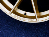 A golden car wheel rim engraved with 