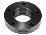 A black metal flange with five bolt holes is resting on a white background. Its circular shape features a central hollow section with a threaded interior.