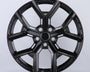 A glossy black car wheel rim features a five-spoke design with intricate detailing, set against a plain white background.