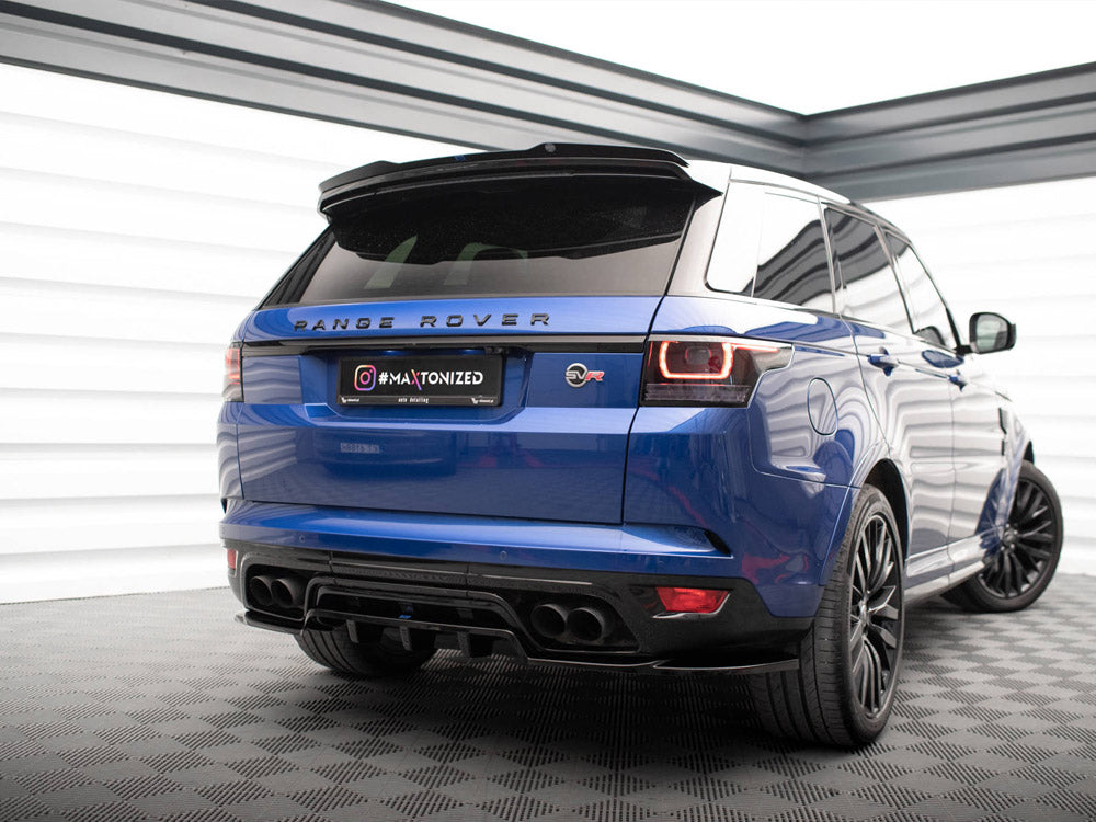 A blue Range Rover is parked in a well-lit showroom on a checkered floor. The back view showcases its black wheels and tail lights. Text: "RANGE ROVER" and "#MAXTONIZED."