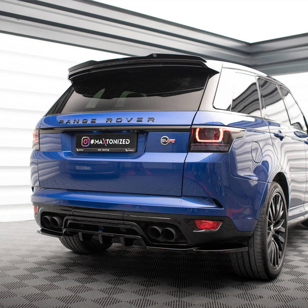 A blue Range Rover is parked in a well-lit showroom on a checkered floor. The back view showcases its black wheels and tail lights. Text: "RANGE ROVER" and "#MAXTONIZED."