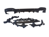 A set of black car bumper parts is laid out against a plain, white background, featuring a main bumper and accompanying components organized below it.