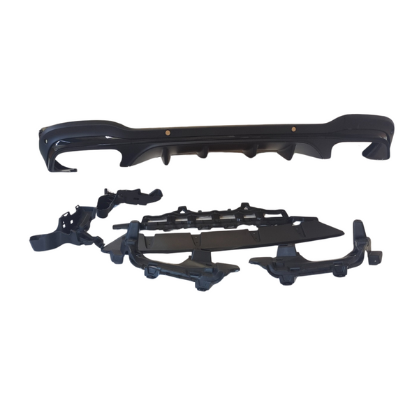 A set of black car bumper parts is laid out against a plain, white background, featuring a main bumper and accompanying components organized below it.