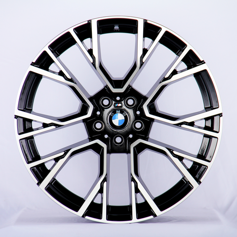 A black and silver alloy wheel with a BMW emblem at the center, displaying a sleek design against a plain white background.