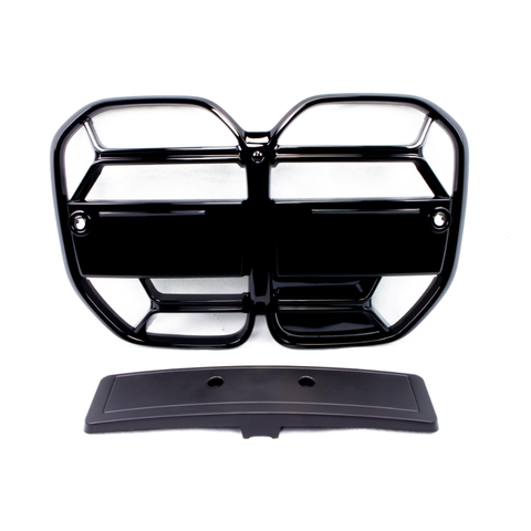 A black, glossy vehicle grille with a geometric pattern lays flat, accompanied by a separate rectangular piece below it, on a plain white background.